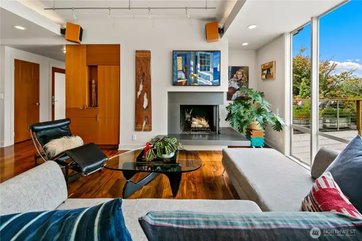 Gather around the granite fireplace in a living space warmed by walnut floors and vertical grain fir. Expansive windows dissolve the walls, threading Olmsted’s parkland calm into daily life.