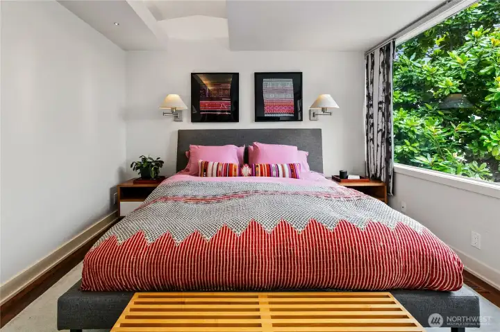 Awake to the quiet of Olmsted’s woodland, framed by windows that draw the forest inside. With two walk-in dressing rooms and direct access outdoors, the main-level owner’s suite is both convenient and secluded—its own private wing apart from daily life.