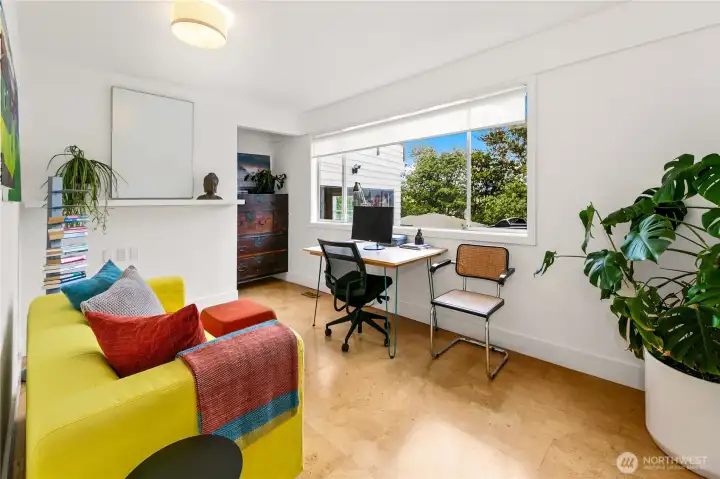 A bright lower-level bedroom easily flexes as a home office or studio, with windows drawing in park greenery. Its adaptability reflects the home’s design ethos—spaces that shift gracefully with life’s needs while rooted in Olmsted’s woodland calm.