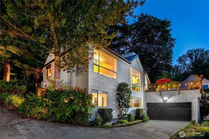 An integrated two-car garage is complemented by generous driveway space and guest parking above. Rare for a woodland setting, this Interlaken residence pairs parkland privacy with the everyday ease of ample parking.