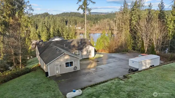 Enjoy sunrises from your east facing view. Swartz Lake in the background to the NW. Notice the side door exit to the extra-large garage. There's plenty of room for vehicles, RV'S, all your toys.