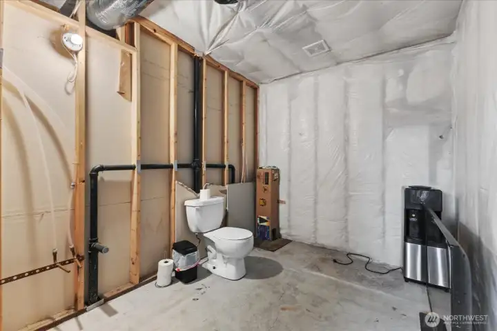 Lower level, 8' x 10' unfinished bathroom. Toilet operational. Plumbed and ready for your design
