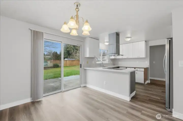 Glass Sliders Open To Large Fenced Backyard