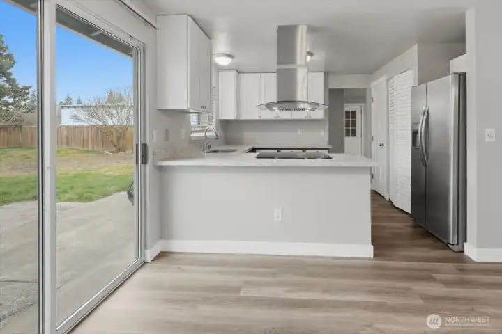 Open Kitchen Features New White Cabinets & New S.S.Hood Over Sleek Glass Stove Top