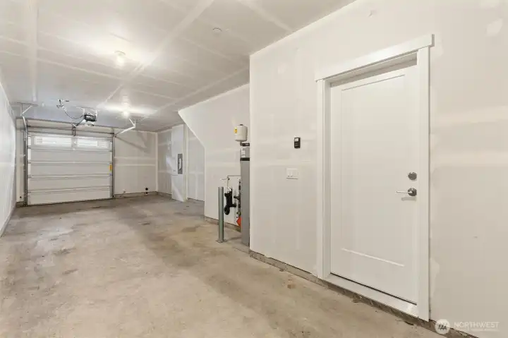Two car tandem garage with room for storage shelves on the left side.