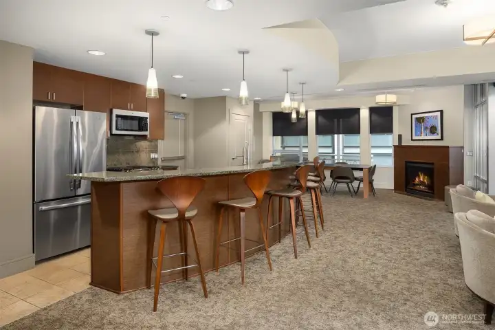Full kitchen, dining area, and cozy fireplace in the clubhouse.