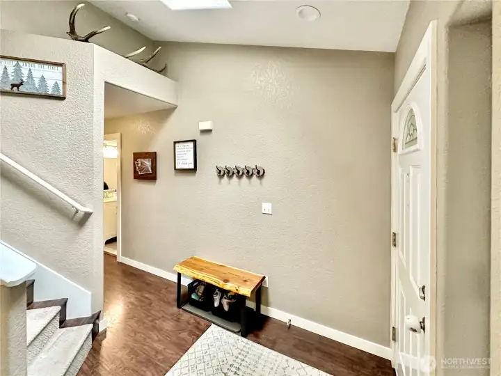 Another view of entry, powder room and closet just down the hallway.