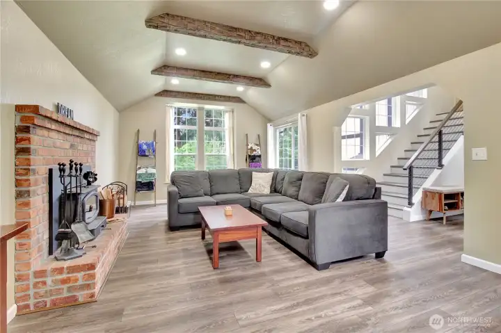 The living room is quiet and set apart with high windows at both ends to fill the room with natural light.