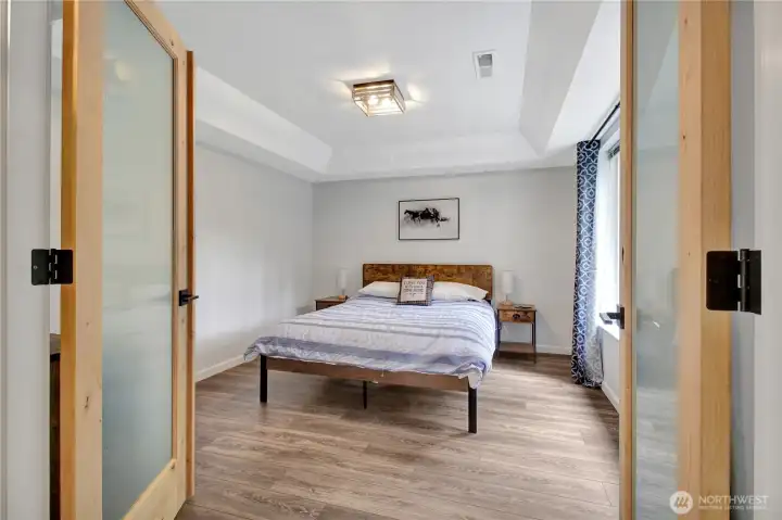 This main floor bedroom has been a formal dining room as well as an office