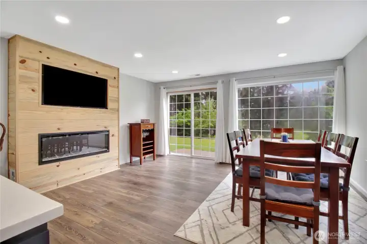 This dining area adjacent to the kitchen features an electric fireplace and built in TV. Sliders to back yard and pastures.