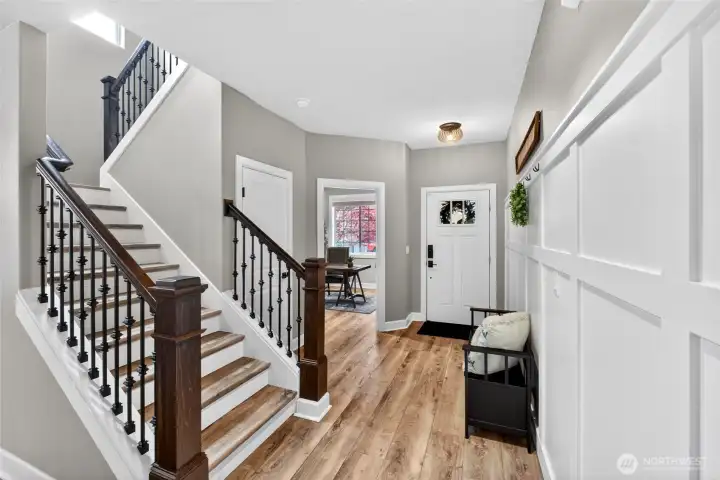 Extra wide stairway featuring open railing with metal knuckle accented spindles.