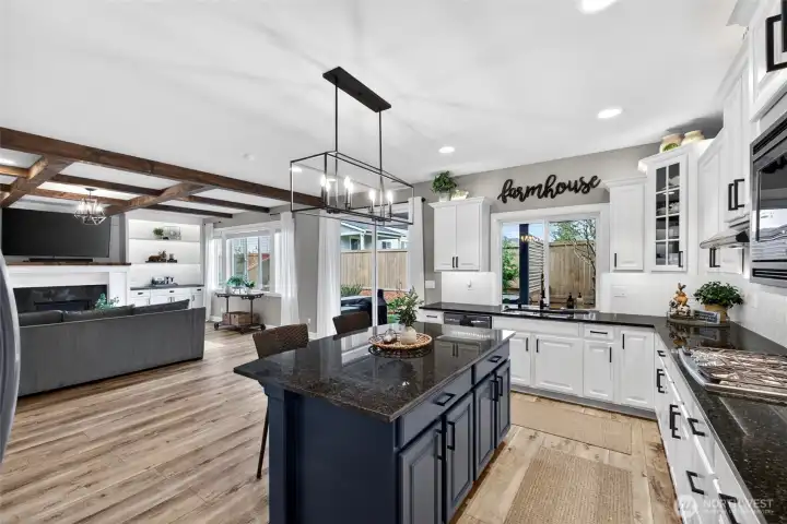 Two-tone cabinetry adds the perfect pop of color! Island offers plenty of storage and extra seating.