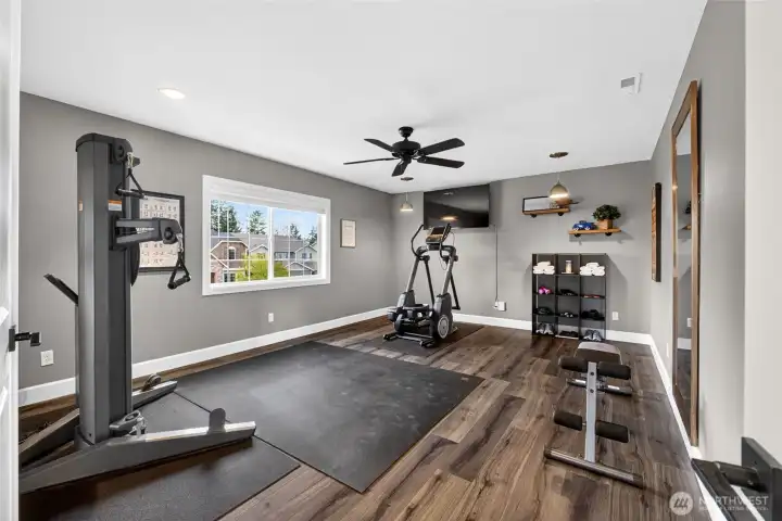 Front bonus room with French doors, LVP and ceiling fan. Or use as a rec room, playroom, game room, giant bedroom, etc. Versatile for your specific needs!!