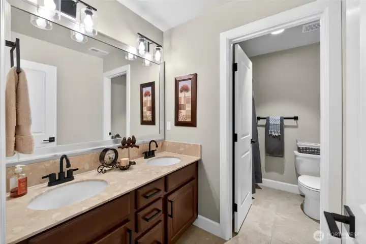 Hall bathroom is great for sharing with the separated shower/toilet room and dual sink vanity! Lights are motion activated.
