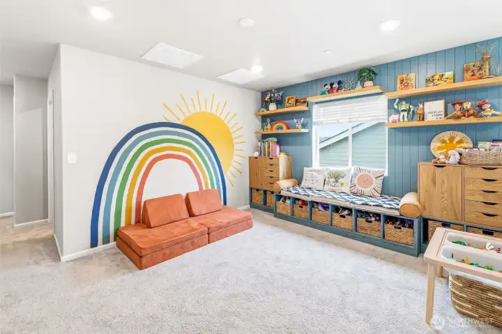 Custom wall and built-in bench and storage remain.  Custom mural charming and a bright spot for all.