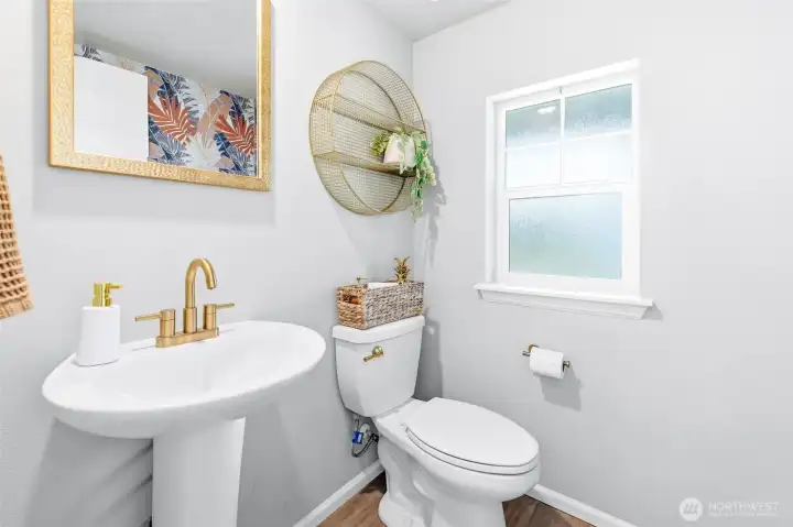 Guest powder room is convenient in the foyer/stairwell, and has gold fixtures for a little but of luxe!