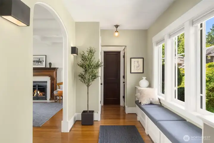 A sophisticated entry foyer transitions beautifully past a cozy, built-in daybed. A sophisticated entry foyer transitions beautifully past a cozy, built-in daybed.