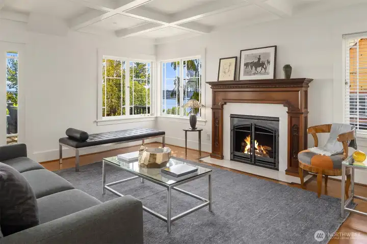 A bright, elegant living room centered around a stately custom hearth. A bright, elegant living room centered around a stately custom hearth.