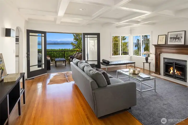 Black-framed French doors and modern sconces anchor the room for dramatic lake views. Black-framed French doors and modern sconces anchor the room for dramatic lake views.