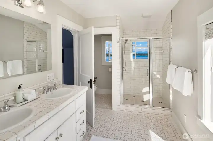 The spacious primary ensuite with a view-inspired shower. The spacious primary ensuite with a view-inspired shower.