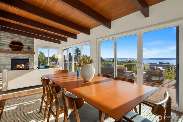 Wall-to-wall windows with sliding doors that open up to wrap around deck.