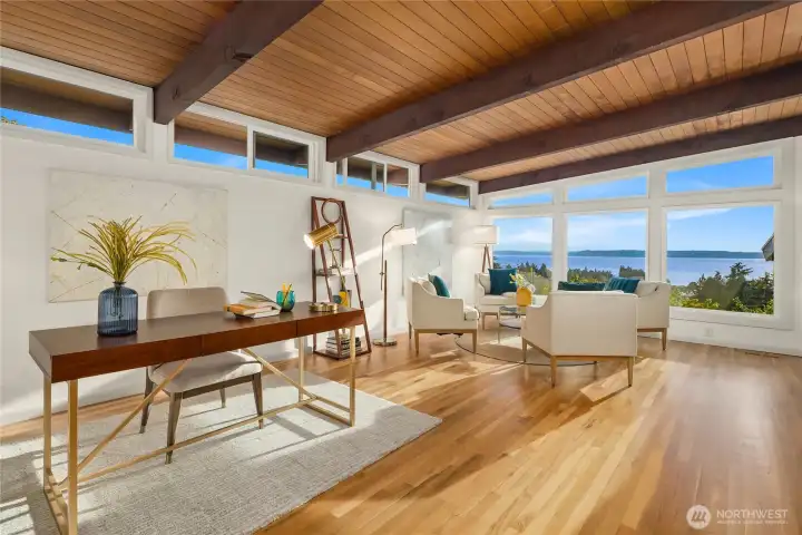 Upstairs den with hardwood floors. Floor-to-ceiling west-facing windows face Puget Sound and the peninsula. Perfect for additional lounge space and a private office.
