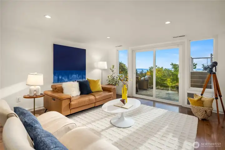 Sliding glass door off den open to paver patio that connects to concrete path down to workshop and storage.