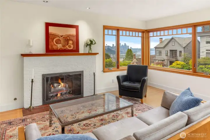 Sparkling city views from spacious living room with gas fireplace. Sparkling city views from spacious living room with gas fireplace.