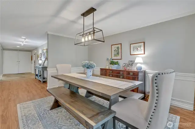 Another view of dining, with chair-rail & cove molding. Simple yet elegant chandelier.