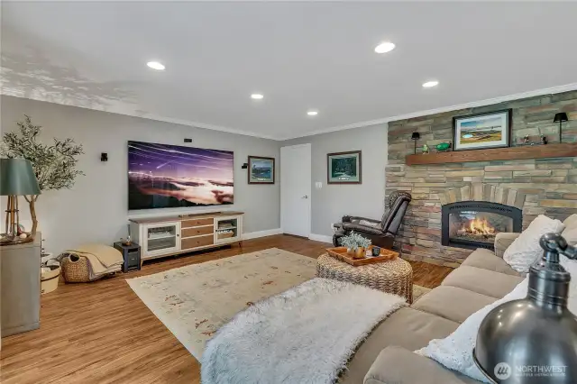 Again, Family Room has gas fireplace with stone surround, mantle for Christmas Stockings & treasures!  Doorway to laundry. Again, note the number of canned lights!