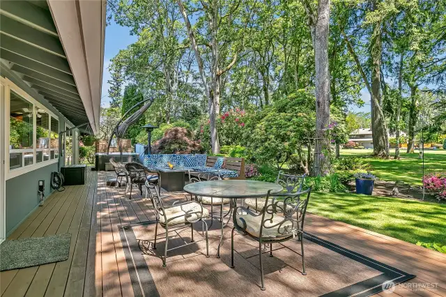 Nearly 1000 sq. ft deck with hot tub, pond with waterfall, firepit & barbeques all plumbed for natural gas. Backyard with mature plantings and golf course beyond.