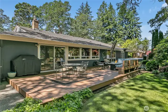 Entirety of nearly 1000 sq. ft. deck.  Natural gas plumbed for barbeque, generous seating areas, pond with waterfall, hot tub, and more! Golf cart garage just to left out of picture.