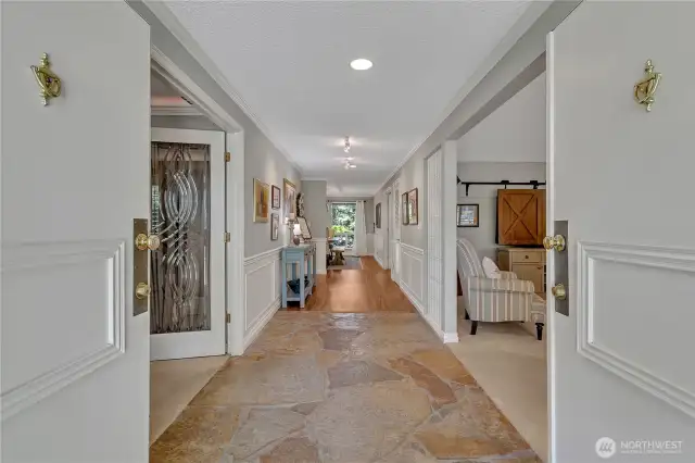 Generous foyer with slate flooring. You can see the golf course from here, all the way down the hallway and out the window!!