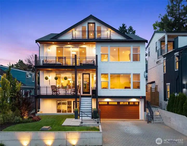This stunning modern home offers a perfect blend of luxury and comfort, featuring expansive windows that flood the interior with natural light and provide breathtaking views.