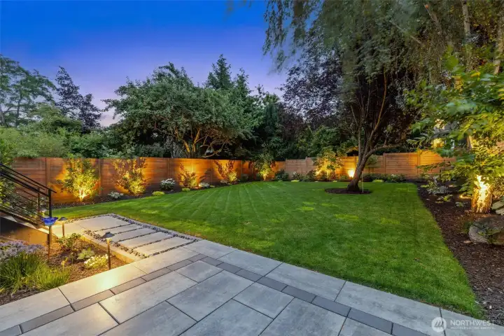 The beautifully landscaped yard and spacious deck are ideal for gatherings or quiet evening