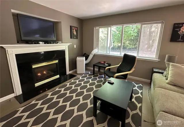 nviting Family Room. Large picture windows overlook back deck and naturally landscaped backyard.