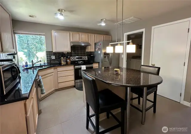 Kitchen - view from sliding glass door area shows center island and pantry area.