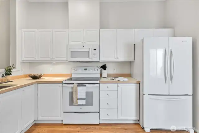 Clean, fresh look with white cabinetry and matching white appliances.