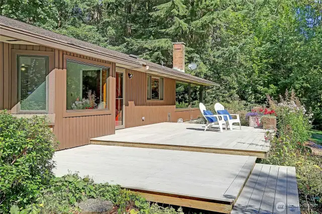 Step outside and into a true sanctuary.  This thoughtfully designed multi-level deck isn't just an extension of the home, it's a seamless bridge to the living, breathing landscape that surrounds it.