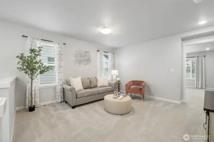 Bright and cozy loft connecting the upper-level bedrooms.