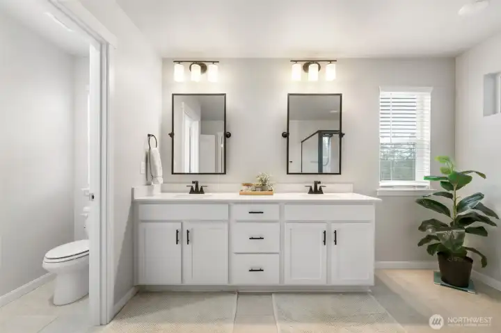 Large primary bathroom featuring an upgraded shower and separate water closet.