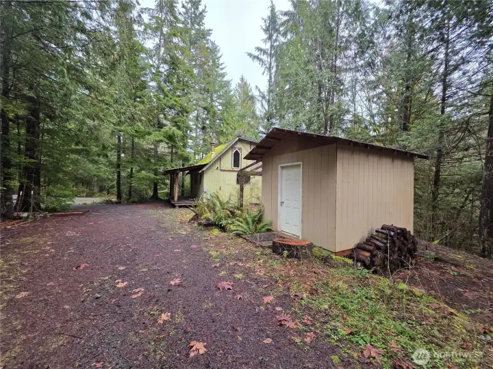 shed with cabin behind it