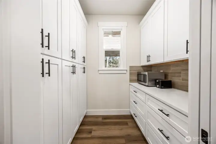 Neatly store all of your kitchen essentials in your Butler's Pantry, adjacent to the kitchen. Pocket door keeps everything neatly out of view.