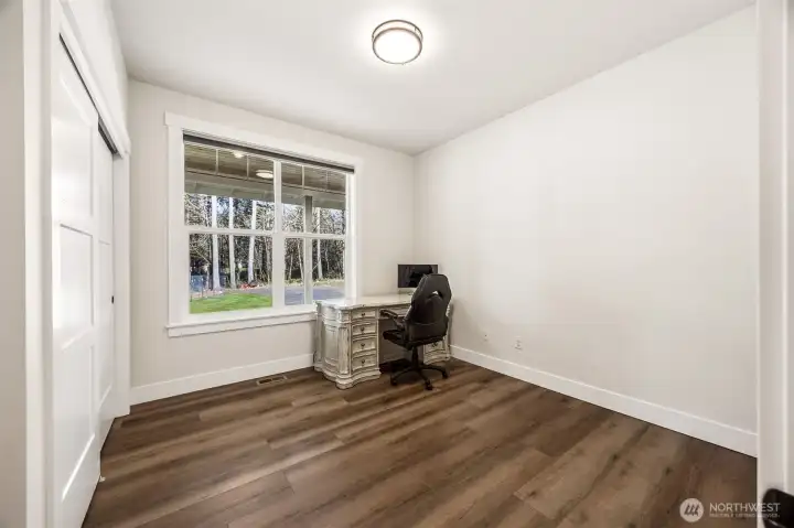 Bedroom #2 (currently used as office space) with Luxury Vinyl Plank Flooring, faces the front yard.