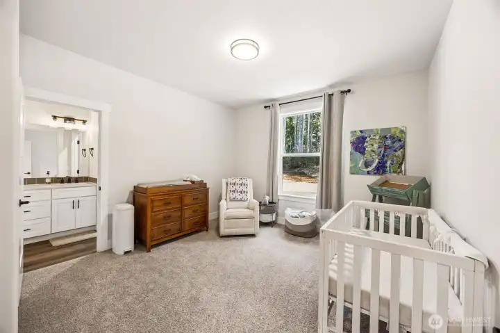 Bedroom #4 with view to the side yard, carpeted floor. Adjoining bathroom is shared with bedroom #3.