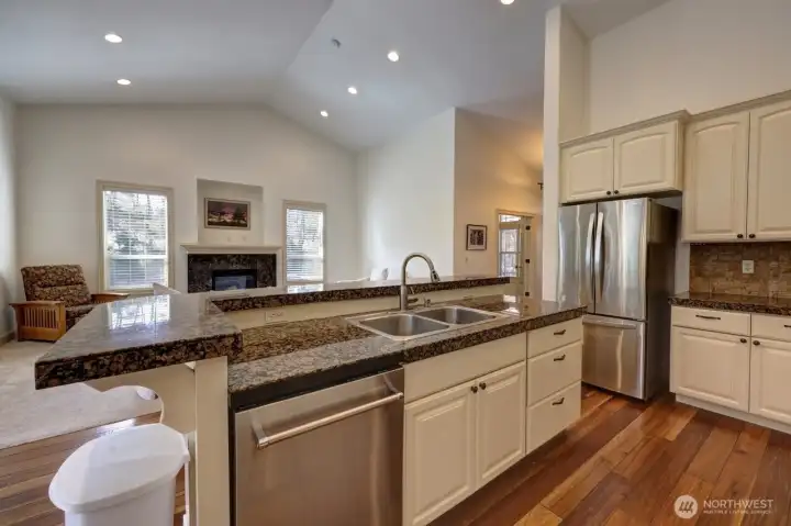 Granite countertops throughout the kitchen. Sink and dishwasher in the island.