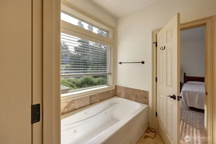 Soaking tub in with the double sinks and the shower (not shown) is in a separate room.
