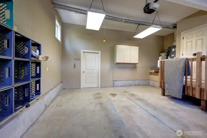 Large garage with a workshop behind the door.