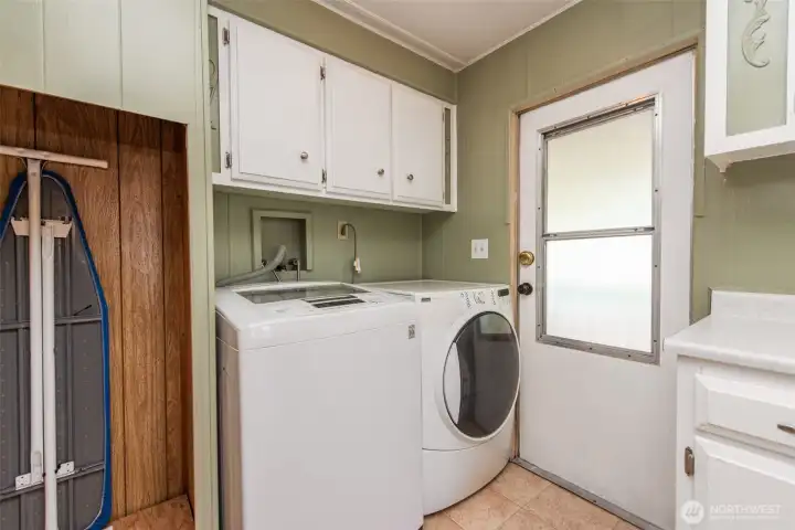 Back entrance with washer and dryer. Back entrance with washer and dryer.