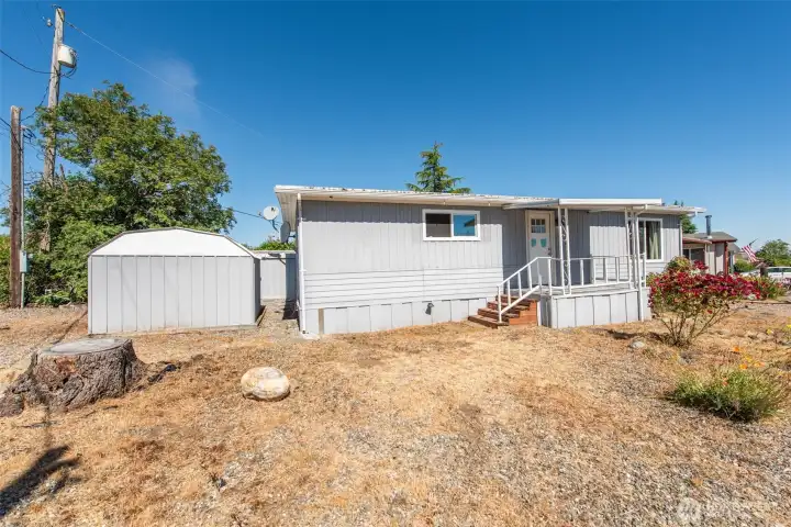 Front of home where front door and small porch are. Second storage shed on the left. Front of home where front door and small porch are. Second storage shed on the left.